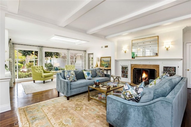 living room featuring beamed ceiling and hardwood / wood-style floors