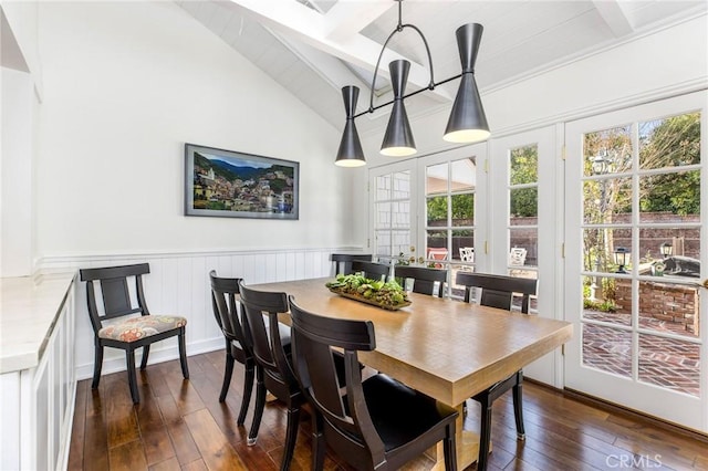 dining space with vaulted ceiling with beams and dark hardwood / wood-style floors