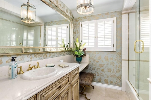 bathroom featuring tile patterned flooring, vanity, shower / bath combination with glass door, and a healthy amount of sunlight