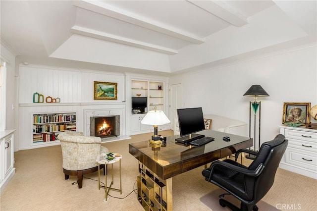 carpeted office featuring built in shelves, a high end fireplace, and beamed ceiling