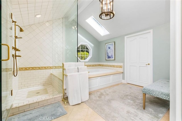 bathroom with vaulted ceiling with skylight, independent shower and bath, and tile patterned flooring