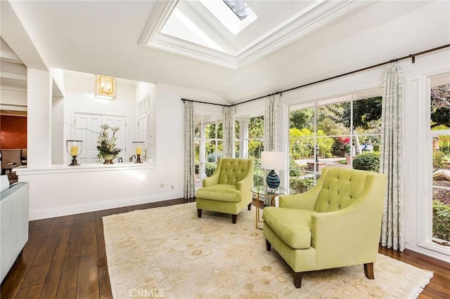 living area featuring hardwood / wood-style floors, lofted ceiling with skylight, and a wealth of natural light