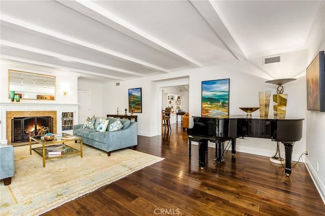 interior space with beam ceiling, a fireplace, and dark hardwood / wood-style floors