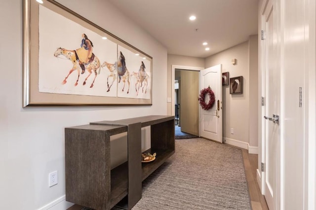 hallway with hardwood / wood-style floors