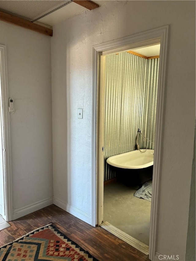 hallway with wood-type flooring and baseboards