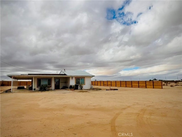 back of house with fence and solar panels