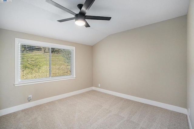 carpeted empty room featuring ceiling fan and vaulted ceiling