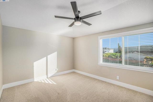 spare room featuring carpet flooring and ceiling fan