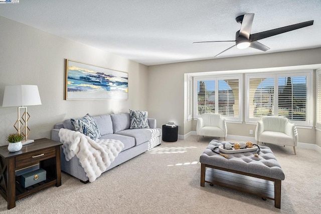 carpeted living room with ceiling fan