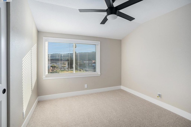 empty room with vaulted ceiling, carpet flooring, and ceiling fan