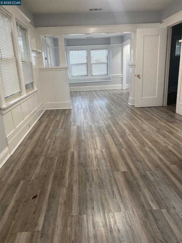 unfurnished living room featuring dark hardwood / wood-style flooring