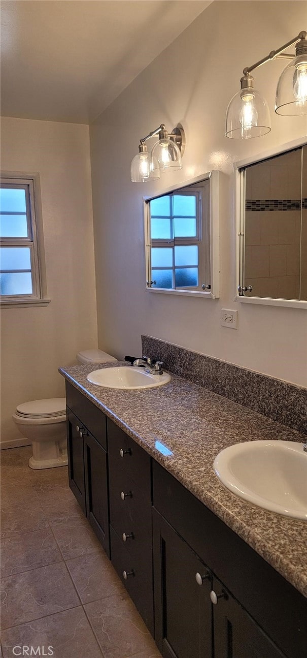 bathroom featuring vanity, toilet, and tile patterned flooring