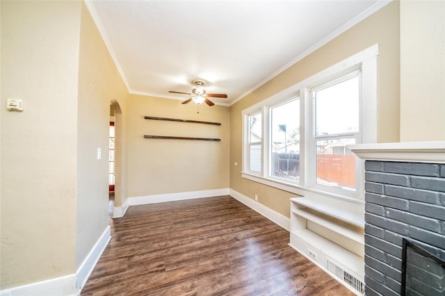 interior space with crown molding, ceiling fan, and dark hardwood / wood-style flooring