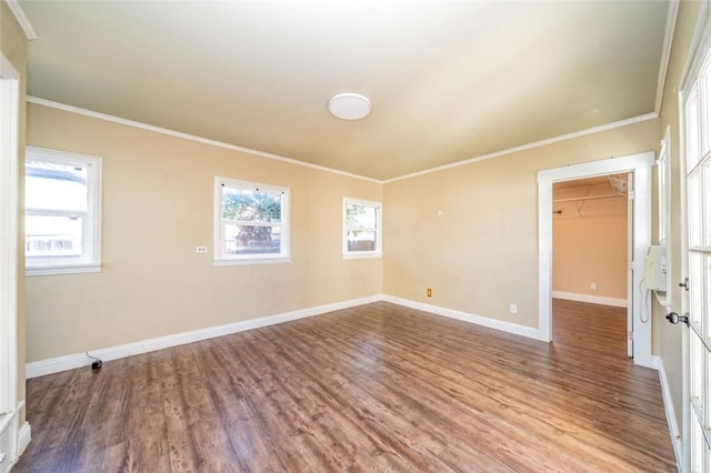 spare room with wood-type flooring and ornamental molding