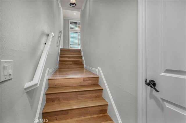 staircase featuring hardwood / wood-style floors