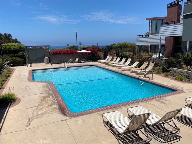 pool with fence and a patio