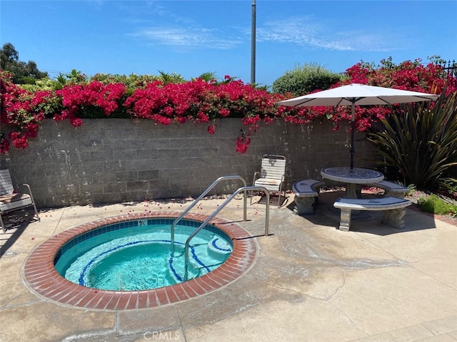 view of swimming pool featuring a patio area, an in ground hot tub, and fence