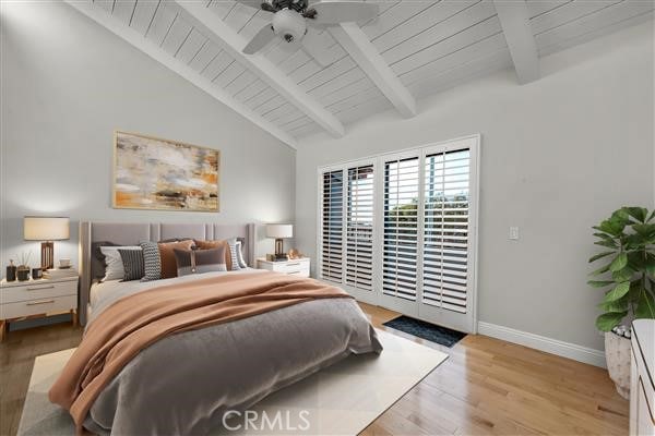 bedroom with baseboards, lofted ceiling with beams, light wood-style flooring, access to exterior, and wood ceiling