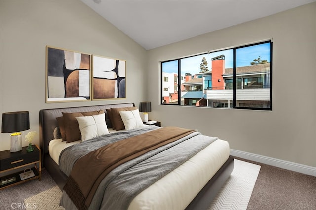 carpeted bedroom featuring baseboards and vaulted ceiling
