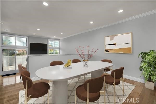 dining room with recessed lighting, baseboards, crown molding, and wood finished floors