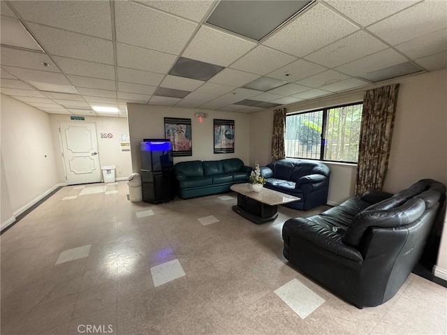 living room with a drop ceiling