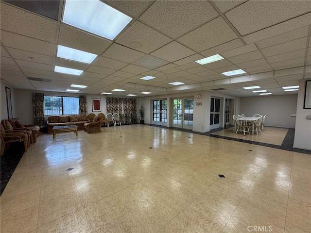 interior space featuring a wealth of natural light and a drop ceiling