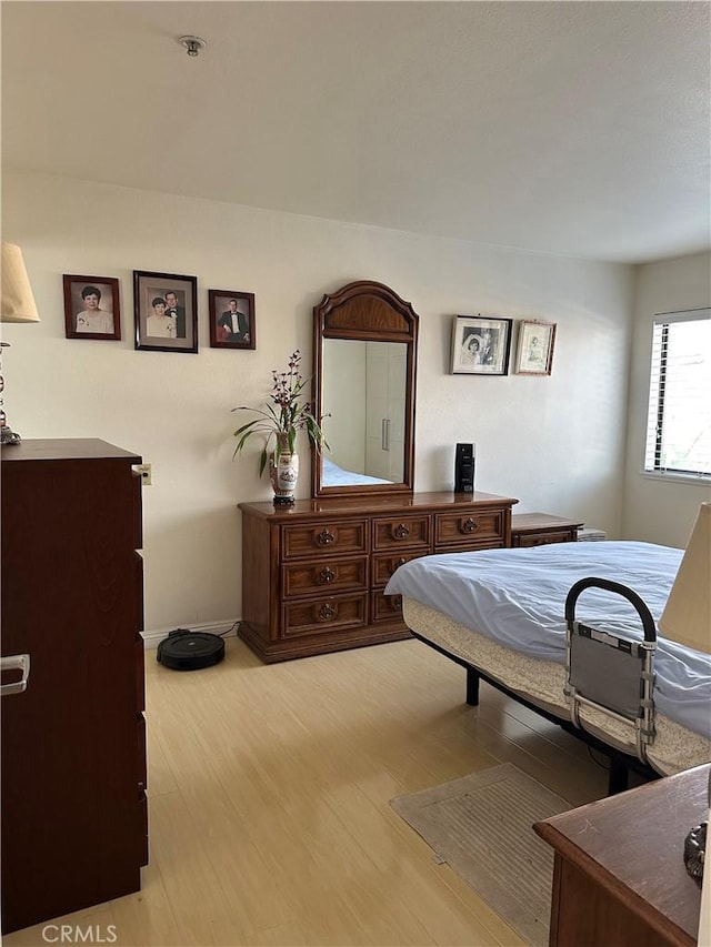 bedroom with light hardwood / wood-style floors