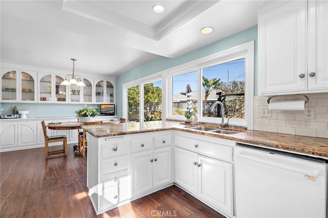 kitchen with white cabinetry, sink, white dishwasher, and decorative light fixtures