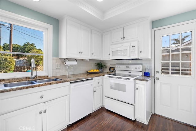 kitchen with sink, dark stone countertops, white cabinets, dark hardwood / wood-style flooring, and white appliances