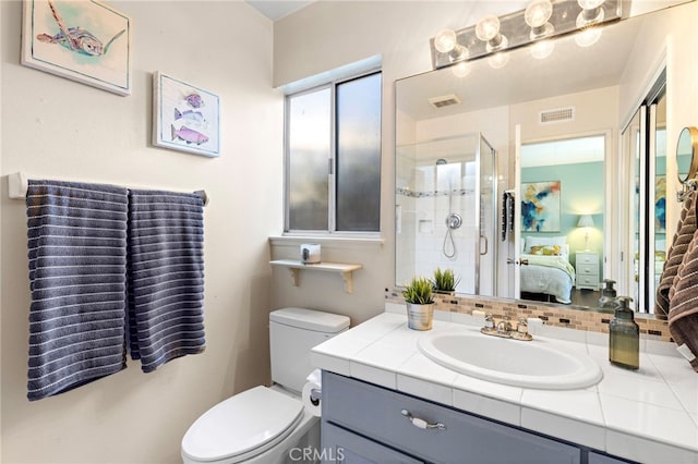 bathroom featuring vanity, toilet, and walk in shower