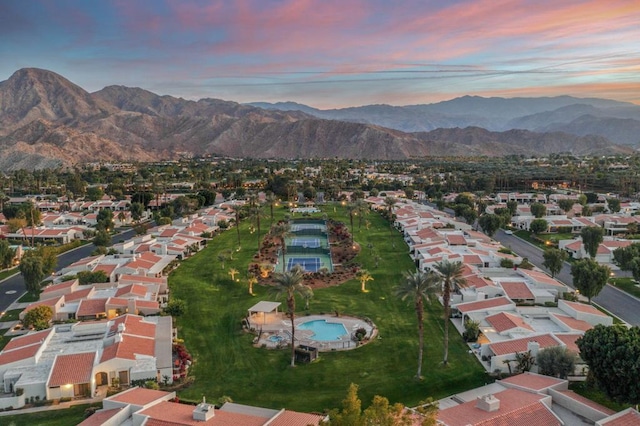 aerial view at dusk featuring a mountain view