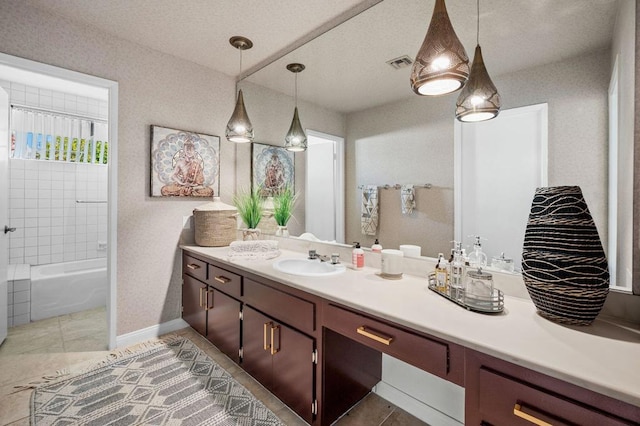 bathroom with vanity, tiled shower / bath combo, and tile patterned floors