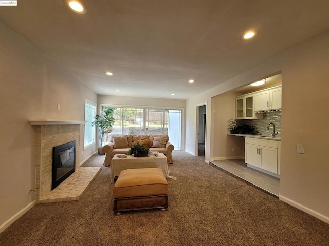 living room with light colored carpet and a fireplace