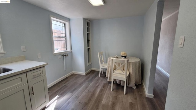 dining room with sink and light wood-type flooring