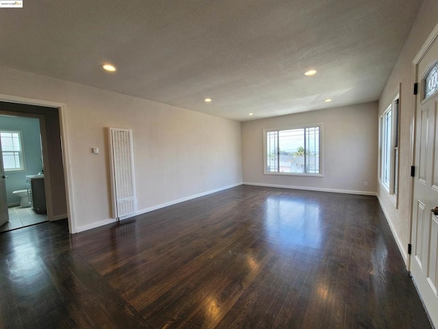 spare room with dark wood-type flooring