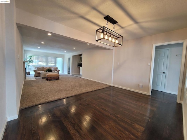 dining room with dark hardwood / wood-style flooring and an inviting chandelier