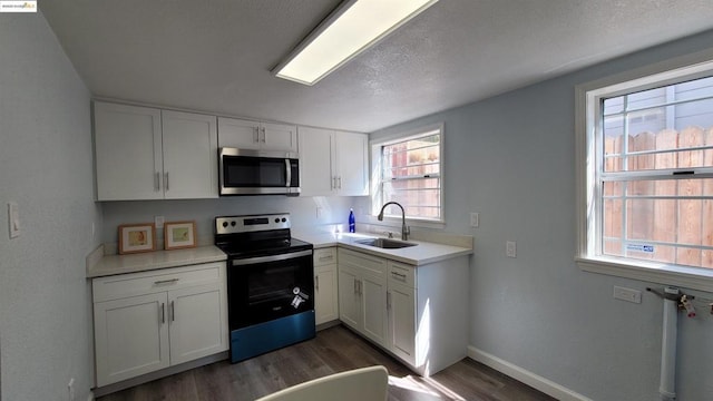 kitchen featuring white cabinetry, a healthy amount of sunlight, stainless steel appliances, and sink