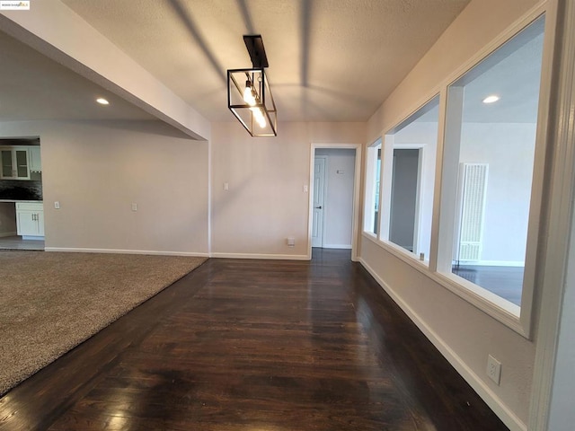 unfurnished dining area featuring dark hardwood / wood-style flooring