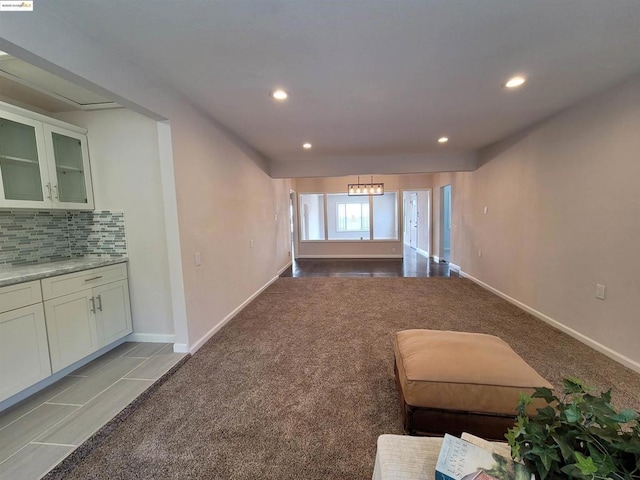 interior space with light tile patterned floors and a notable chandelier