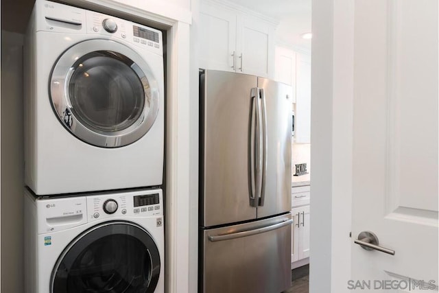 laundry area with stacked washer and clothes dryer