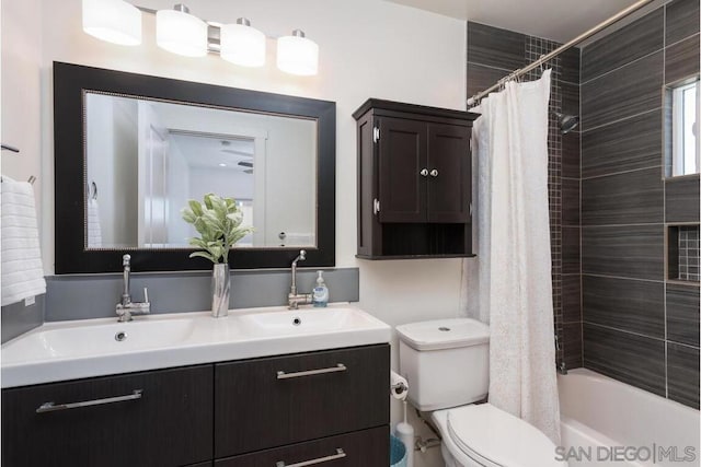 full bathroom with vanity, shower / bath combo with shower curtain, and toilet