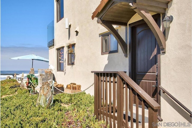 doorway to property with a water view