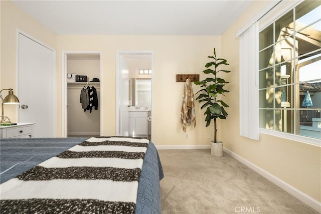 carpeted bedroom featuring ensuite bath and a closet