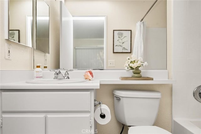 full bathroom with vanity, shower / bathtub combination with curtain, and toilet