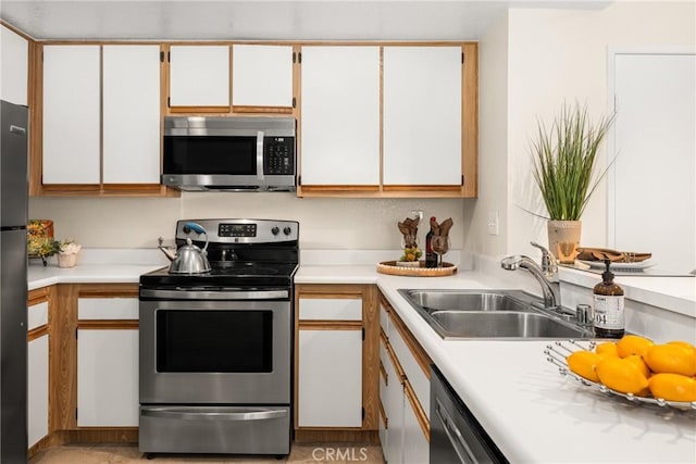 kitchen featuring stainless steel appliances, sink, and white cabinets