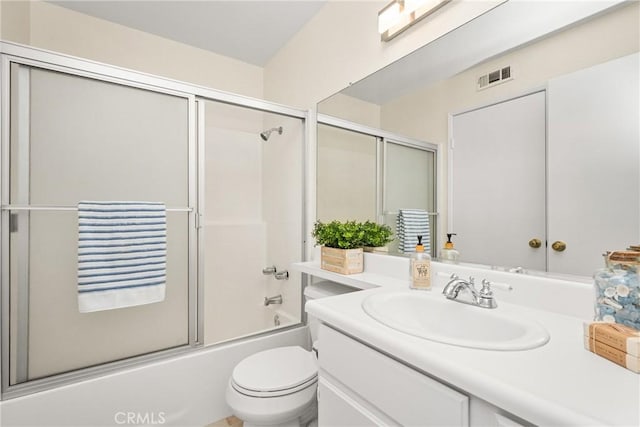 full bathroom with vanity, bath / shower combo with glass door, and toilet