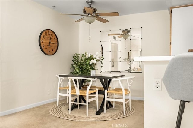 carpeted dining area featuring ceiling fan