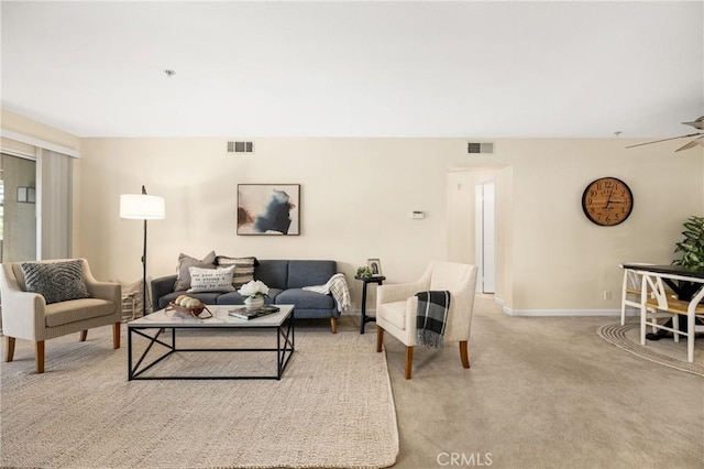 living room with ceiling fan and light colored carpet