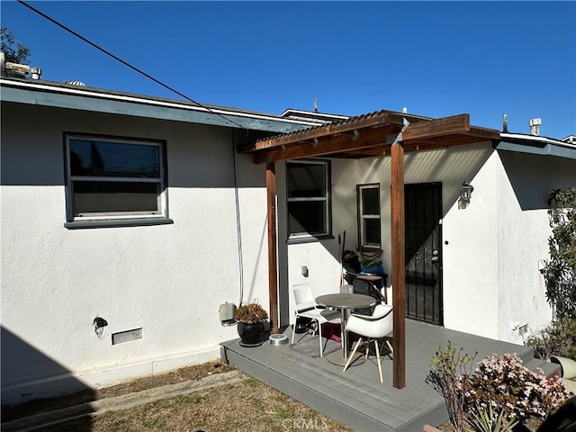 view of side of property featuring a pergola and a deck