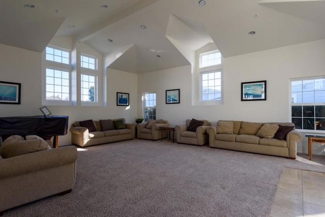 living room featuring beam ceiling, light colored carpet, and high vaulted ceiling